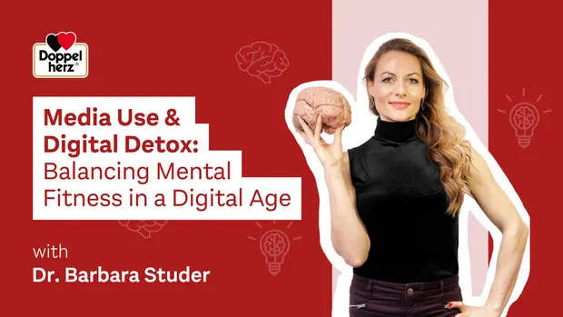 A woman holds a model brain while standing against a colorful background. The text overlay reads, "Media Use & Digital Detox: Balancing Mental Fitness in a Digital Age" with a mention of Dr. Barbara Studer. The image emphasizes the theme of mental health in the digital era.